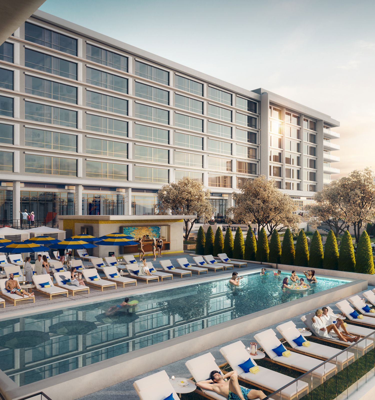 This image shows a modern hotel with a large swimming pool, surrounded by lounge chairs and people relaxing. The building is multiple stories high.